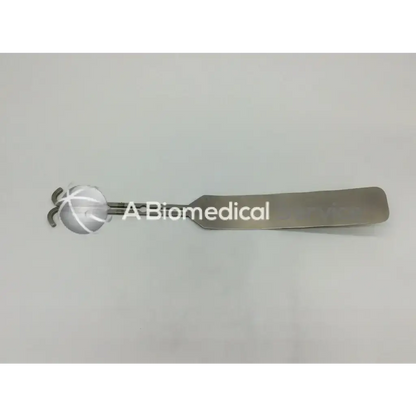 Silver mueller su3032 surgical dixon center blade with rounded textured head and flat elongated handle for surgery