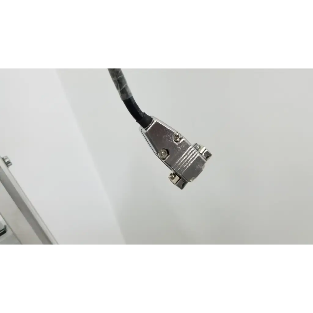 Silver metal d-sub connector with black cable attached on the back of a Varian turbo-v 301-ag navigator vacuum pump system