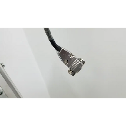 Silver metal d-sub connector with black cable attached on the back of a Varian turbo-v 301-ag navigator vacuum pump system