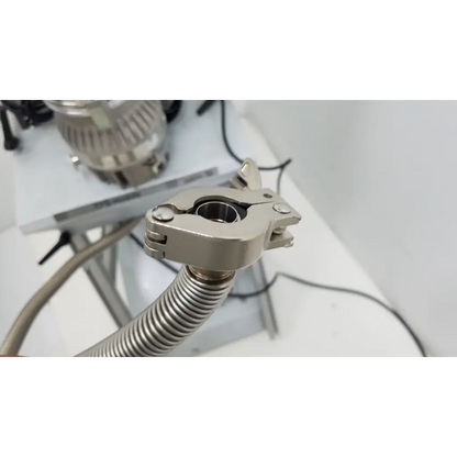 Silver metallic clamp securing flexible corrugated hose on back side of turbo-v 301-ag navigator vacuum pump system