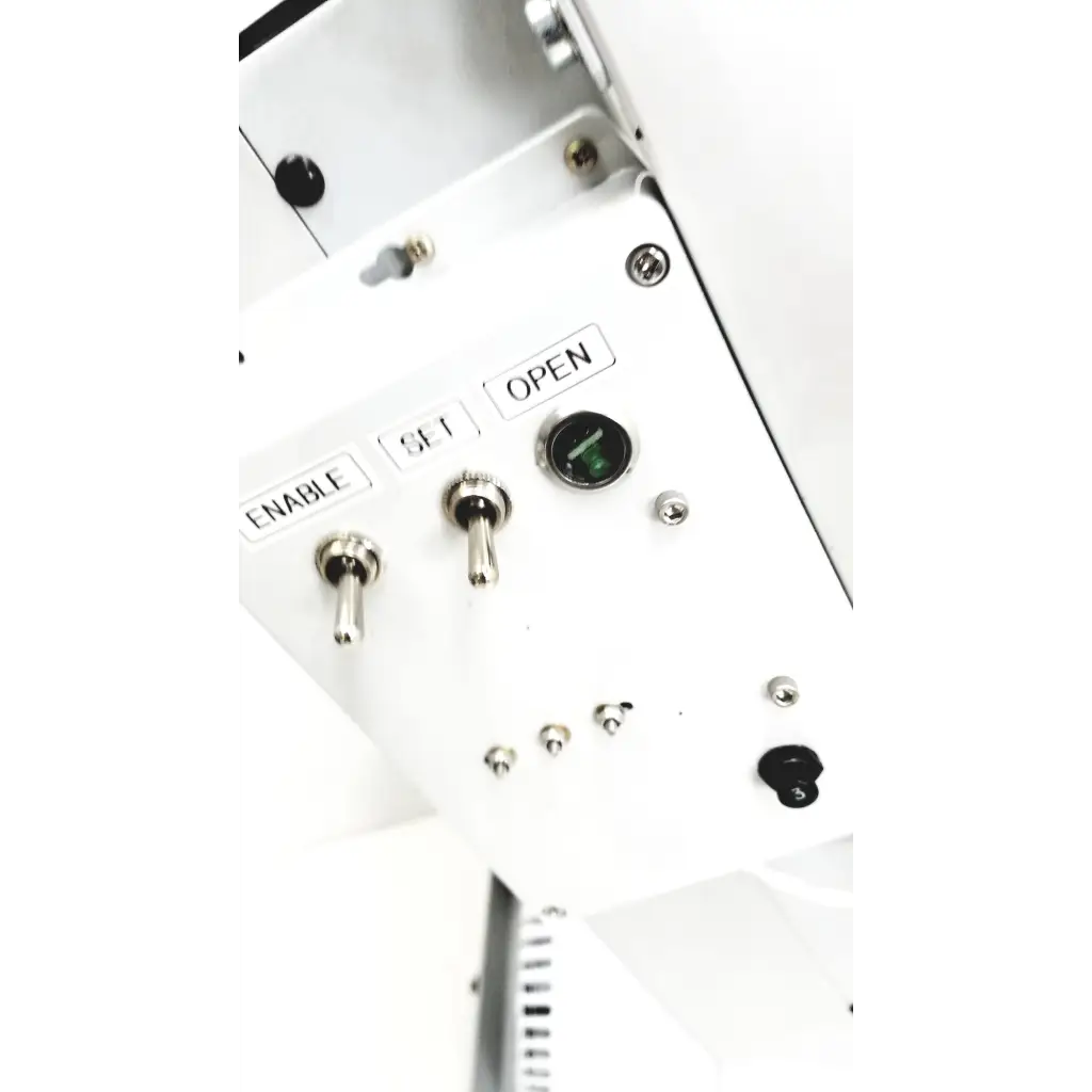 White control panel with silver toggle switches and green indicator on varian turbo-v 301-ag navigator vacuum pump system