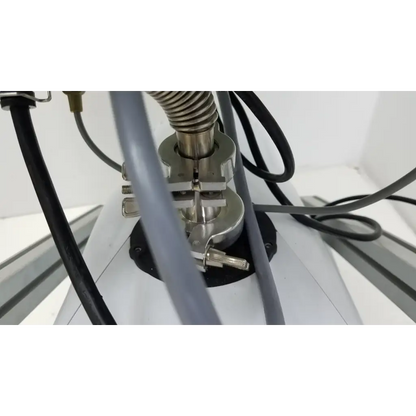 Silver metallic clamp with coiled spring securing gray tubing on the turbo-v 301-ag navigator vacuum pump system