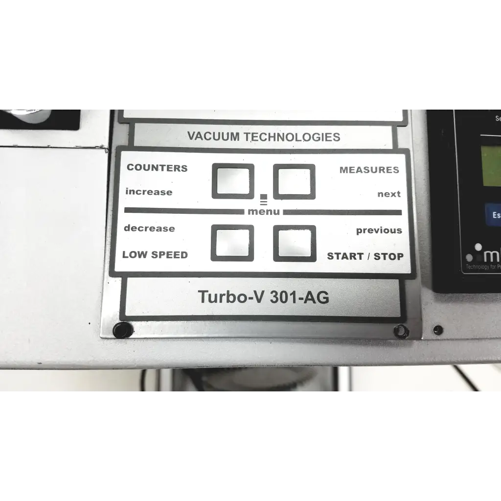 Silver control panel with black labels and buttons on the varian turbo-v 301-ag navigator vacuum pump system