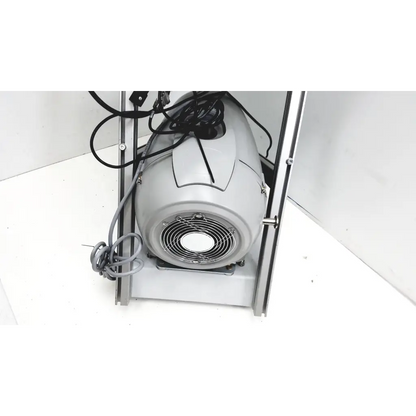 Gray industrial fan with circular grille and coiled black cords on turbo-v 301-ag navigator vacuum pump system back side