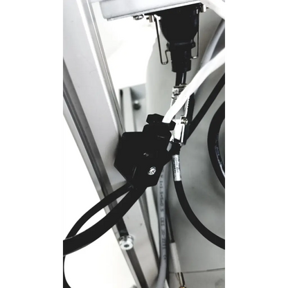 Black plastic cable clamp securing white and black cables to metallic surface on turbo-v 301-ag navigator vacuum pump system