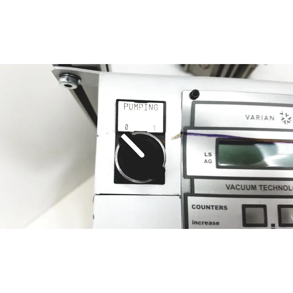 Silver and black control panel of varian turbo-v 301-ag navigator vacuum pump system with pumping dial and white markings