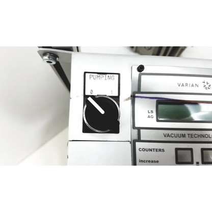 Silver and black control panel of varian turbo-v 301-ag navigator vacuum pump system with pumping dial and white markings