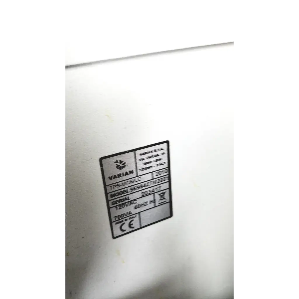 White plastic label with black text showing varian turbo-v 301-ag navigator model details on a medical vacuum pump system