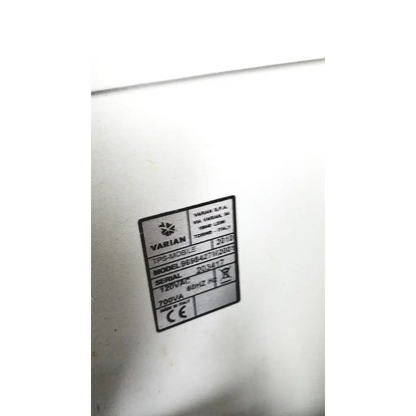 White plastic label with black text showing varian turbo-v 301-ag navigator model details on a medical vacuum pump system