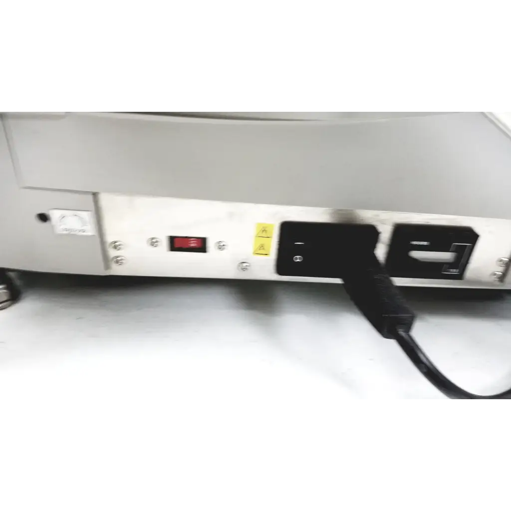 Black power cord plugged into the back of a white Varian turbo-V 301-AG navigator vacuum pump system