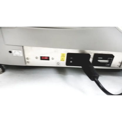 Black power cord plugged into the back of a white Varian turbo-V 301-AG navigator vacuum pump system