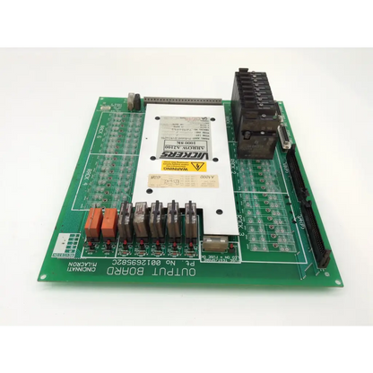 Green printed circuit board with white central module and black orange relays labeled pcb-fsc-471-95 vickers arrow output board
