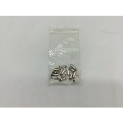 A clear plastic bag containing multiple small shiny silver metal welch allyn transilluminator bulb ad5-326 components