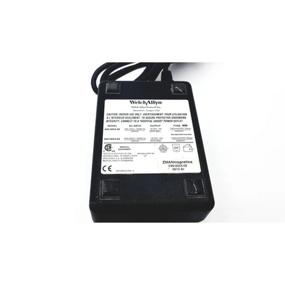 Black plastic welch allyn patient monitor power supply with white label showing technical specifications back side