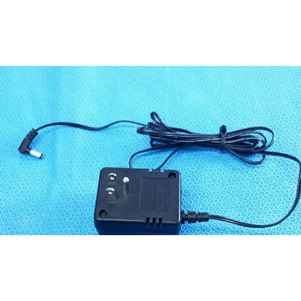Black plastic welch allyn transformer adapter power supply with coiled cable and right-angle connector for 120v use