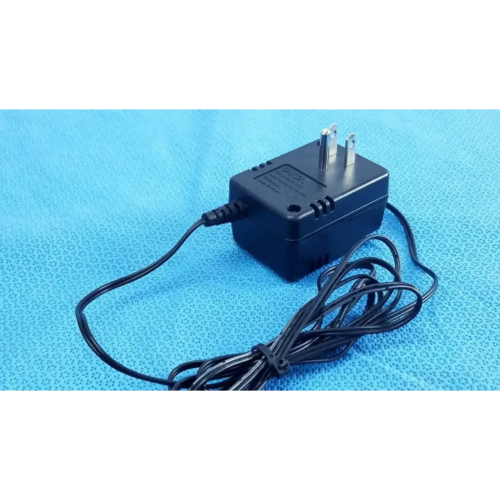 Black plastic welch allyn power supply transformer adapter charger with two-prong plug and coiled black cord