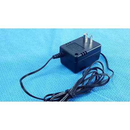 Black plastic welch allyn power supply transformer adapter charger with two-prong plug and coiled black cord