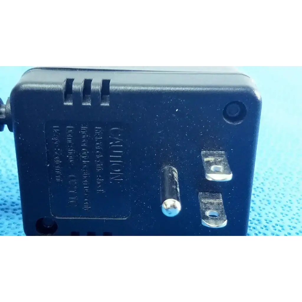 Black plastic welch allyn transformer adapter power supply with two-prong plug and ventilation slots on back side