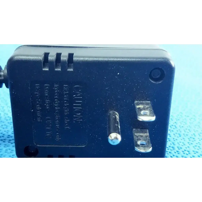 Black plastic welch allyn transformer adapter power supply with two-prong plug and ventilation slots on back side