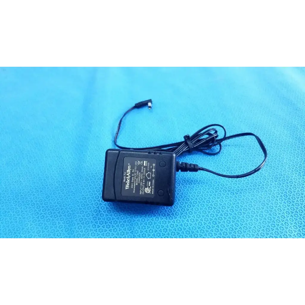 Black plastic welch allyn power supply transformer adapter charger with coiled cable and small cylindrical connector