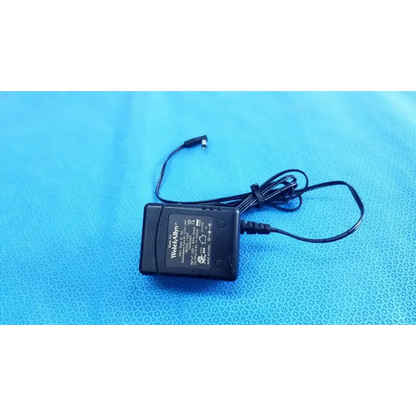 Black plastic welch allyn power supply transformer adapter charger with coiled cable and small cylindrical connector