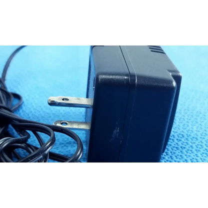 Welch allyn 71040 black plastic transformer adapter power supply with silver prongs and coiled power cord 120v 60hz 50ma