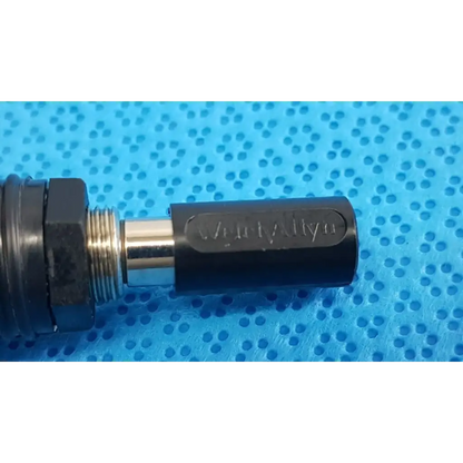 Black and silver verity allen mechanical component with threaded metal shaft of welch allyn 6v power adapter plug