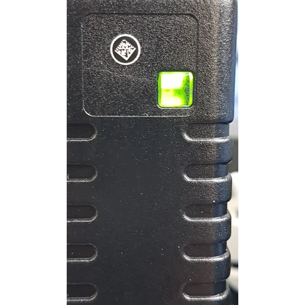 Welch Allyn black textured plastic power adapter plug with glowing green indicator light for medical device use