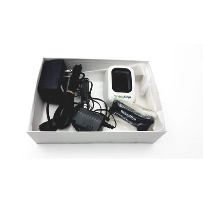 White welch allyn 739 series charger with black rectangular screen branded logo and black power adapters and cables