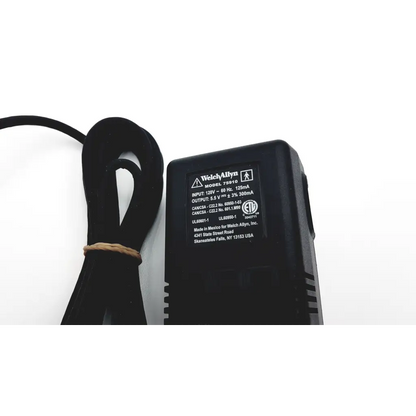 Black plastic welch allyn 739 series charger power adapter with coiled cord tied by brown twine model 73010