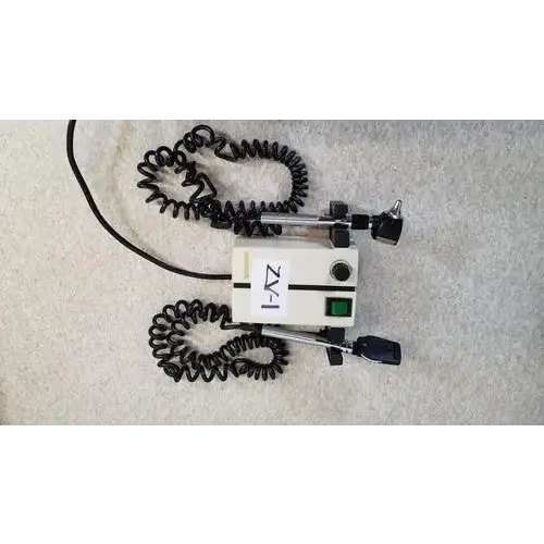 Welch allyn white medical otoscope with black coiled cords and green power button for wall transformer reuse medical use