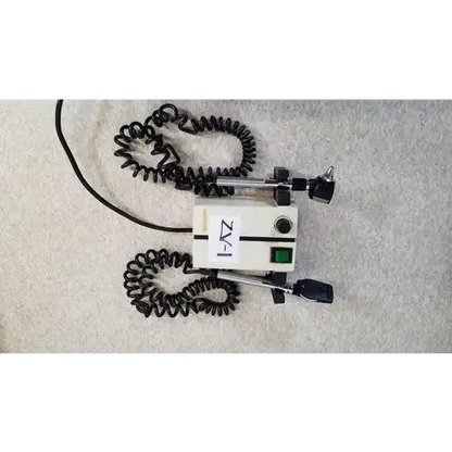 Welch allyn white medical otoscope with black coiled cords and green power button for wall transformer reuse medical use