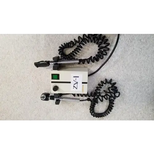 Beige welch allyn 74710 wall transformer with black coiled cords and green power indicator light for reuse medical devices