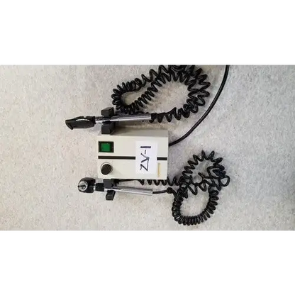 Beige welch allyn 74710 wall transformer with black coiled cords and green power indicator light for reuse medical devices
