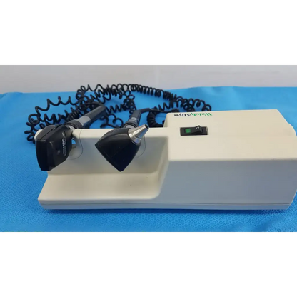 White medical otoscope with black and silver attachments and coiled cord for welch allyn 767 series wall transformer
