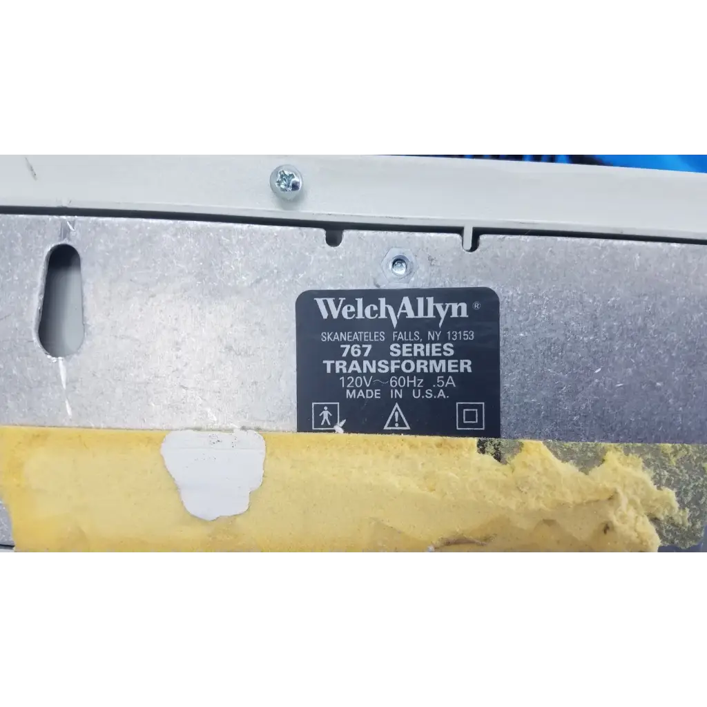 Welch allyn 767 series wall transformer with black label, silver metallic casing, and yellow protective tape at bottom