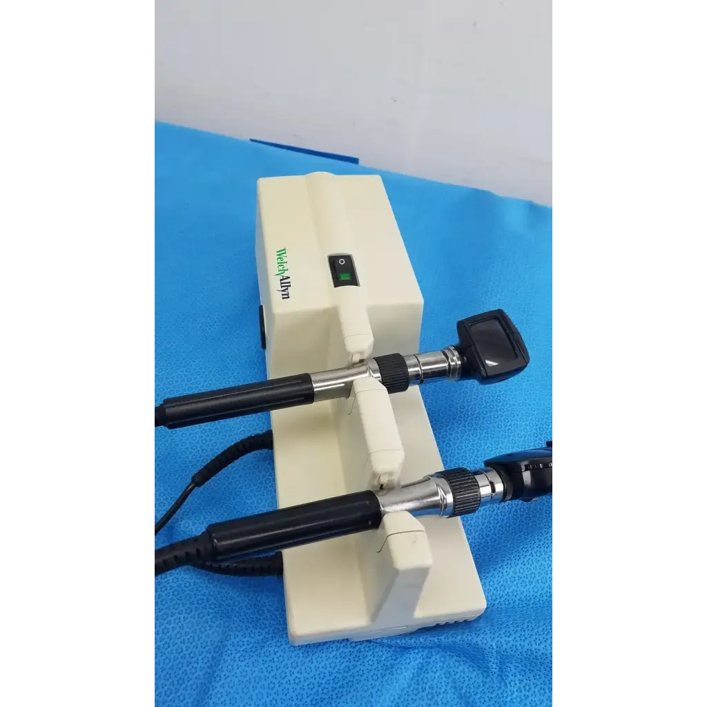 White medical otoscope with black handles and silver joints branded medialpin in welch allyn 767 series wall transformer