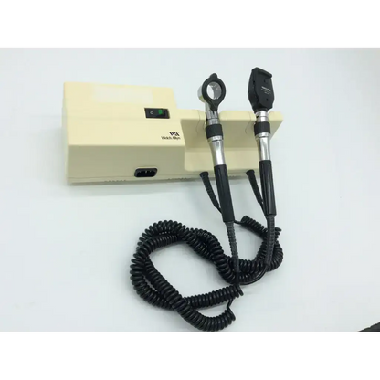 Cream-colored welch allyn otoscope with black and silver handles and coiled cables for series wall transformer use