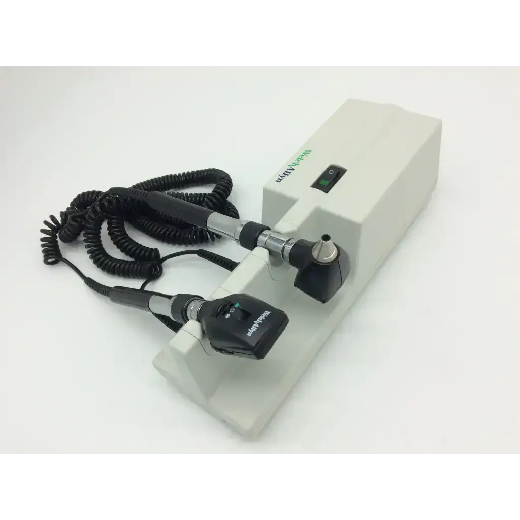 Beckman coulter otoscope with black and silver handle attached to white welch allyn 767 wall transformer 25020a base unit