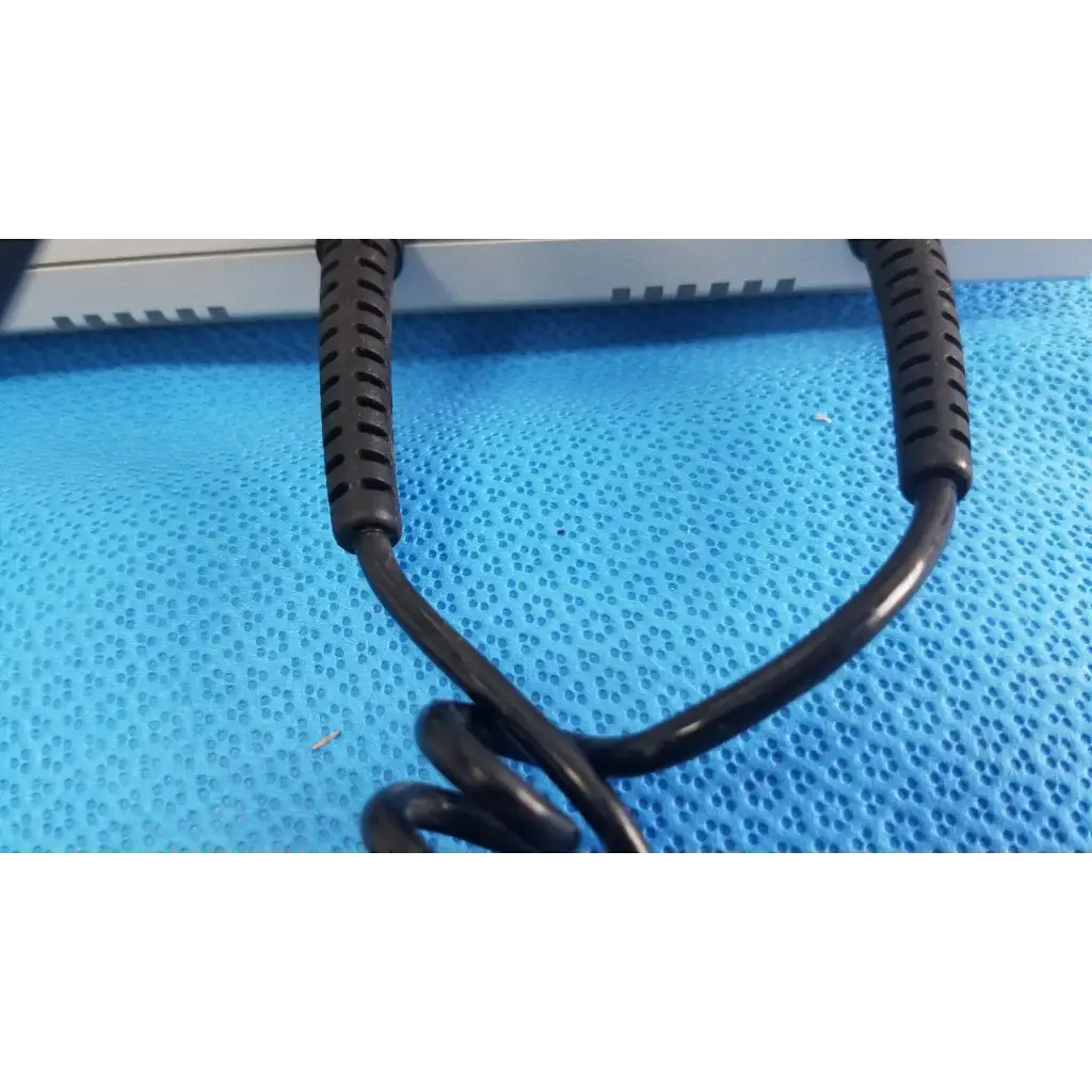 Black coiled cable with textured ribbed connectors for welch allyn wall transformer used in reuse medical devices
