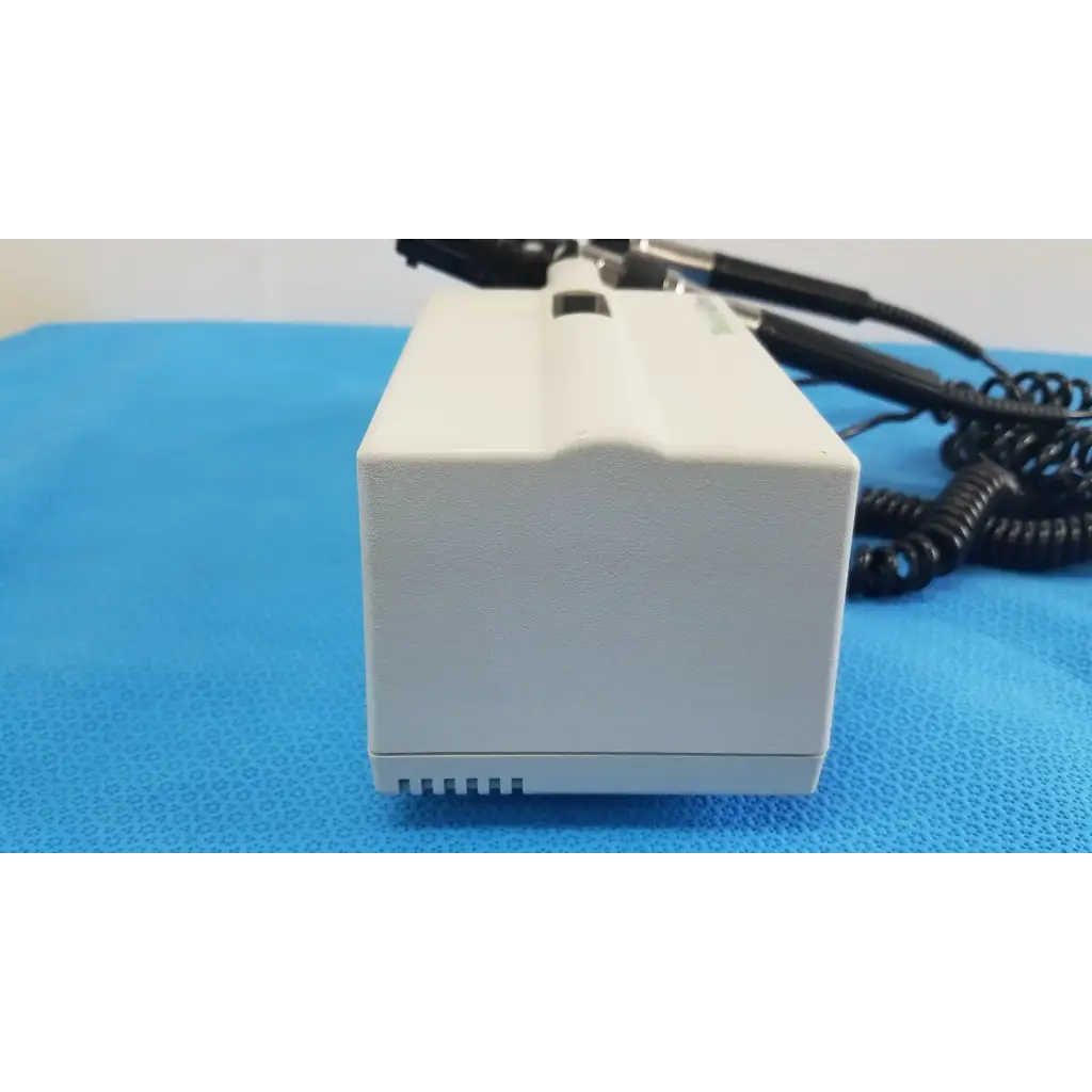 Welch allyn white rectangular wall transformer with black coiled cables and small slot for reuse medical devices