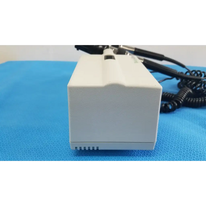 Welch allyn white rectangular wall transformer with black coiled cables and small slot for reuse medical devices