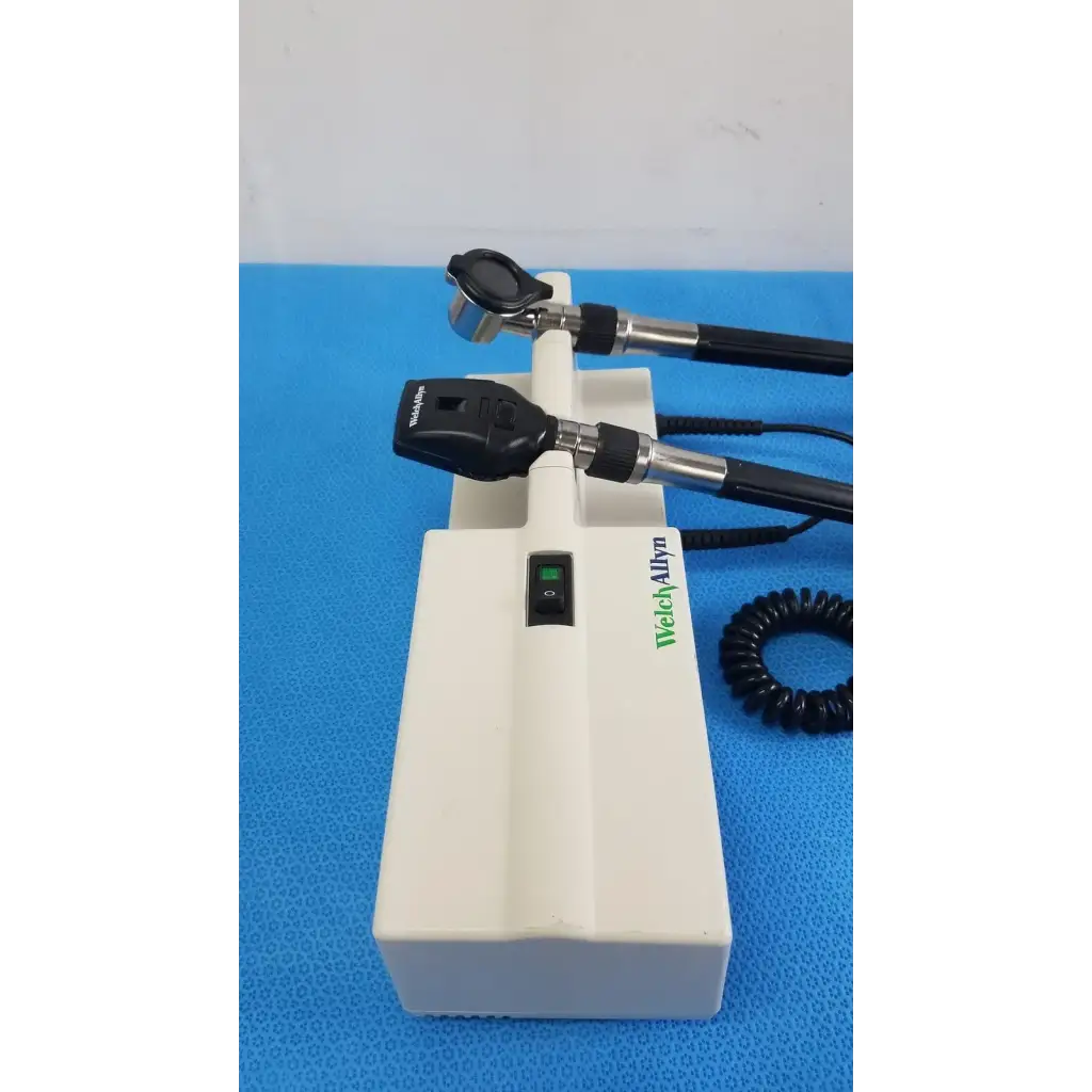 Welch Allyn white plastic wall transformer base with two black and silver reuse medical otoscope heads