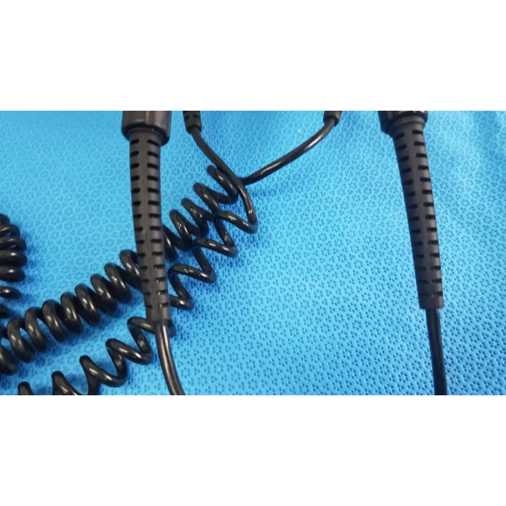 Black coiled cable with textured ribbed connectors for welch allyn wall transformer reuse medical applications