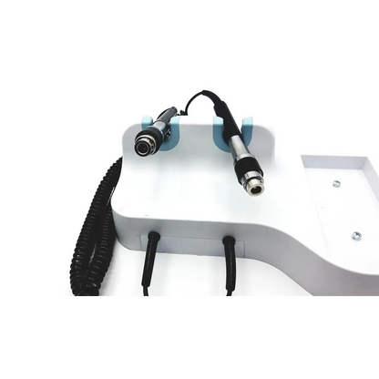 White medical-grade laser hair removal device with black-handled applicators on light blue holders in welch allyn connex integrated wall system