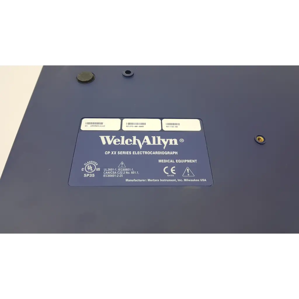 Dark blue welch allyn cp10 ekg machine with certification label and manufacturer info on the back side of the device