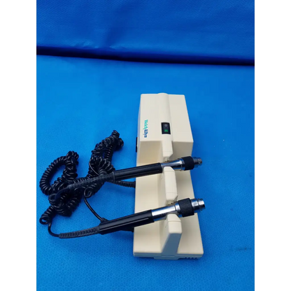 Cream-colored welch allyn diagnostic wall transformer with two black-handled probes and coiled cord no heads visible