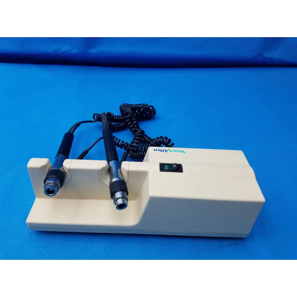Cream-colored welch allyn diagnostic laser device with black-handled probes and coiled cables branded weldaly