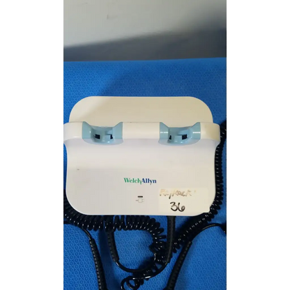 Welch allyn gs 777 wall transformer with white body light blue plastic grips and black coiled cords for reuse medical use