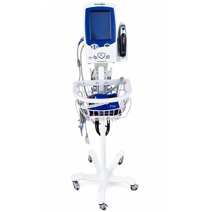 White medical cart with blue and white welch allyn spot vital signs monitor and wire basket holding supplies
